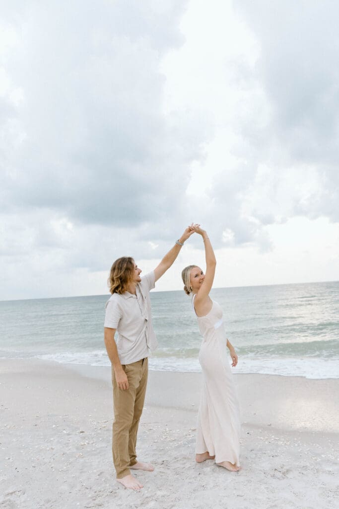 Soft cloudy skies over the Gulf during a romantic engagement session in Naples Florida