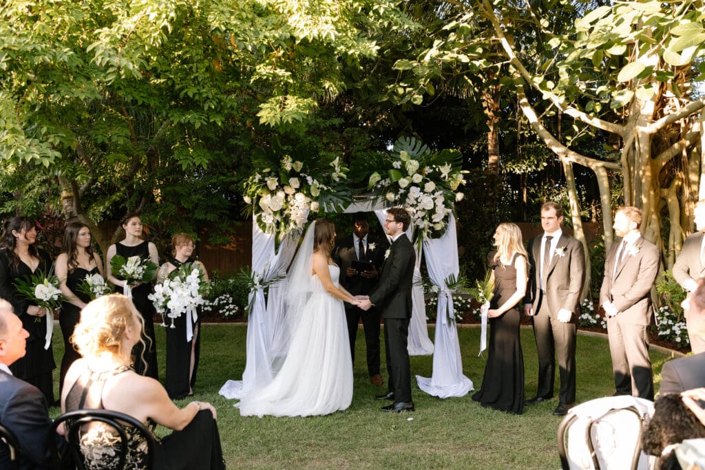 Bride walking down the aisle during colorful Naples Florida outdoor wedding