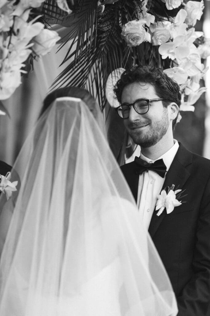 Bride and groom exchanging vows at lush garden wedding in Naples Florida