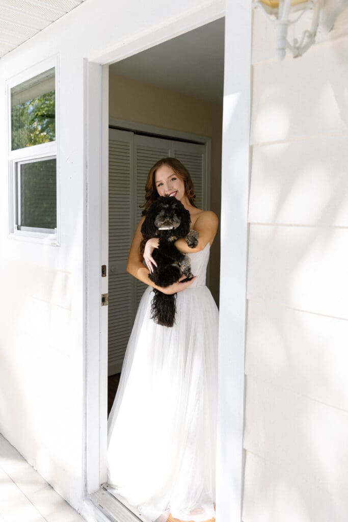 Bride in natural window light preparing for colorful tropical Naples wedding