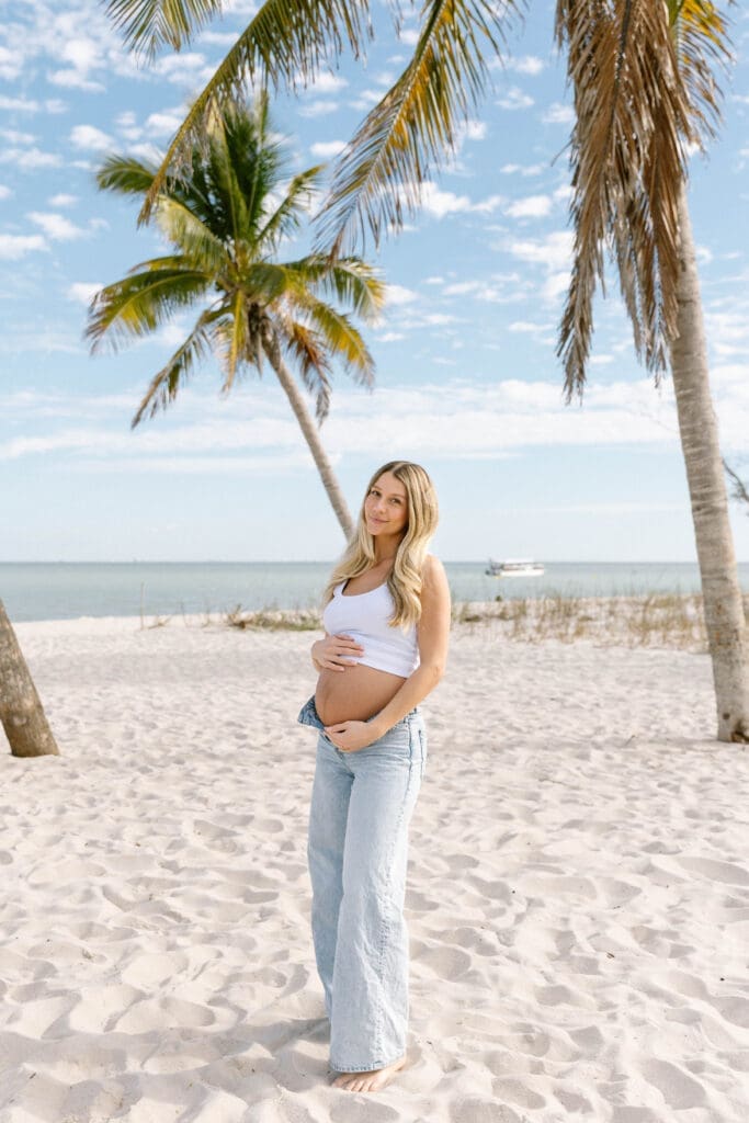 sanibel maternity photographer couple under palm trees