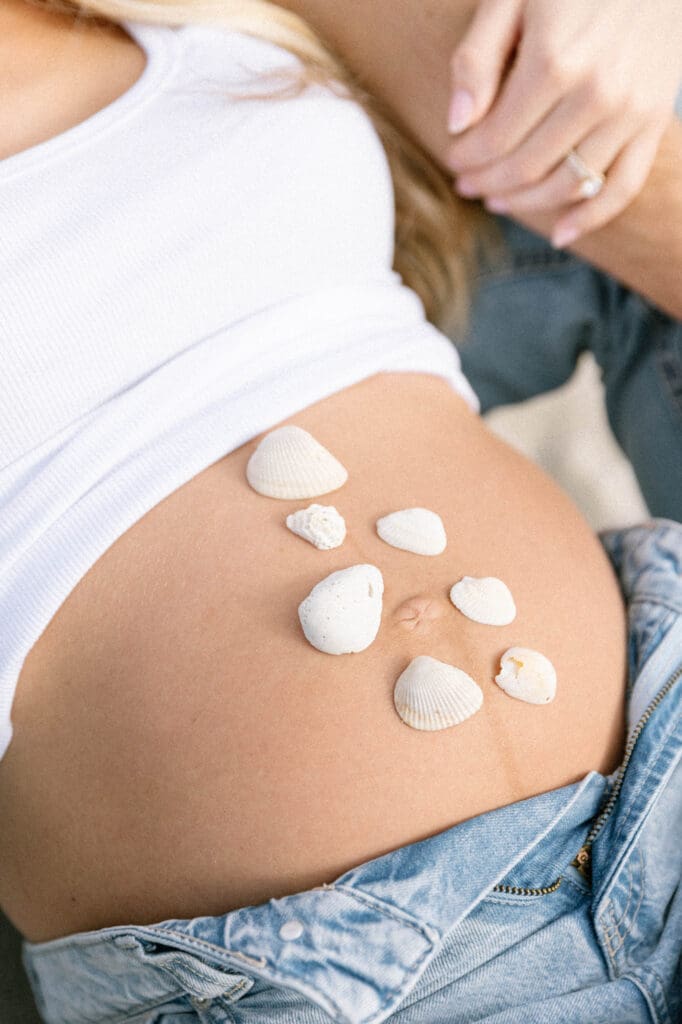 coastal maternity photos white outfit denim beach florida