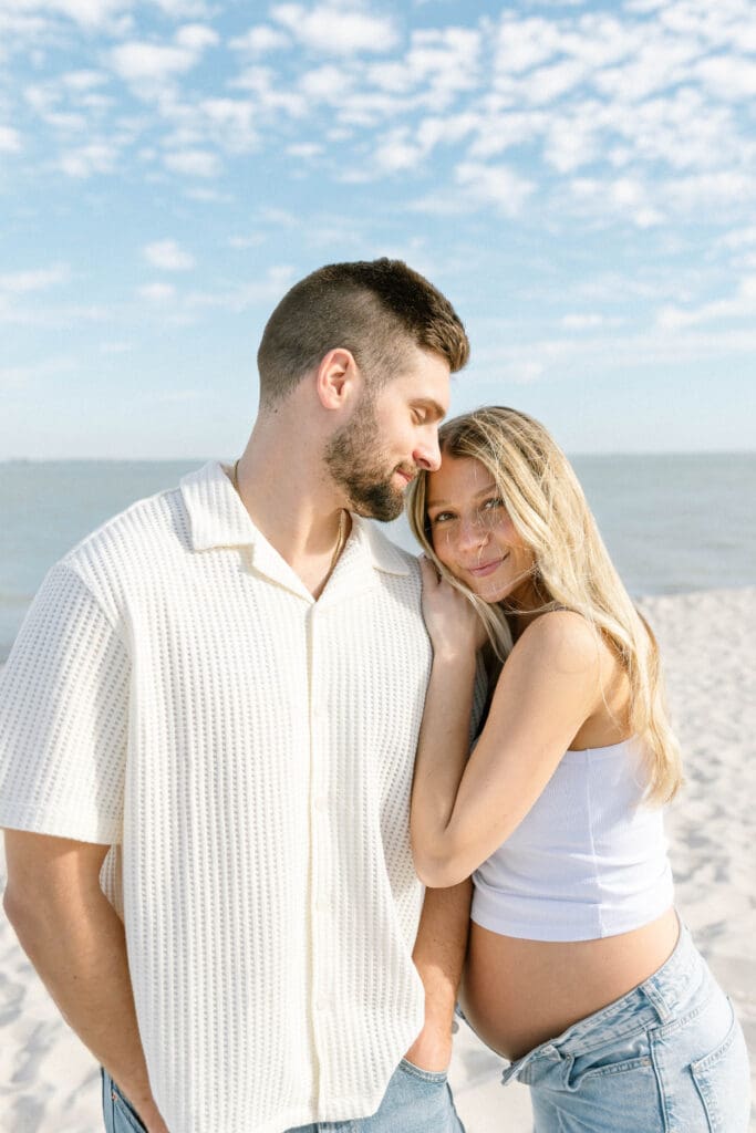 florida beach maternity session couple holding hands at sunset
