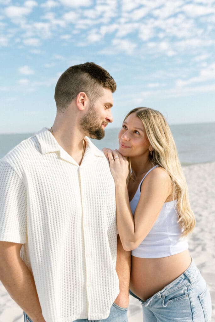 florida beach maternity session couple holding hands at sunset