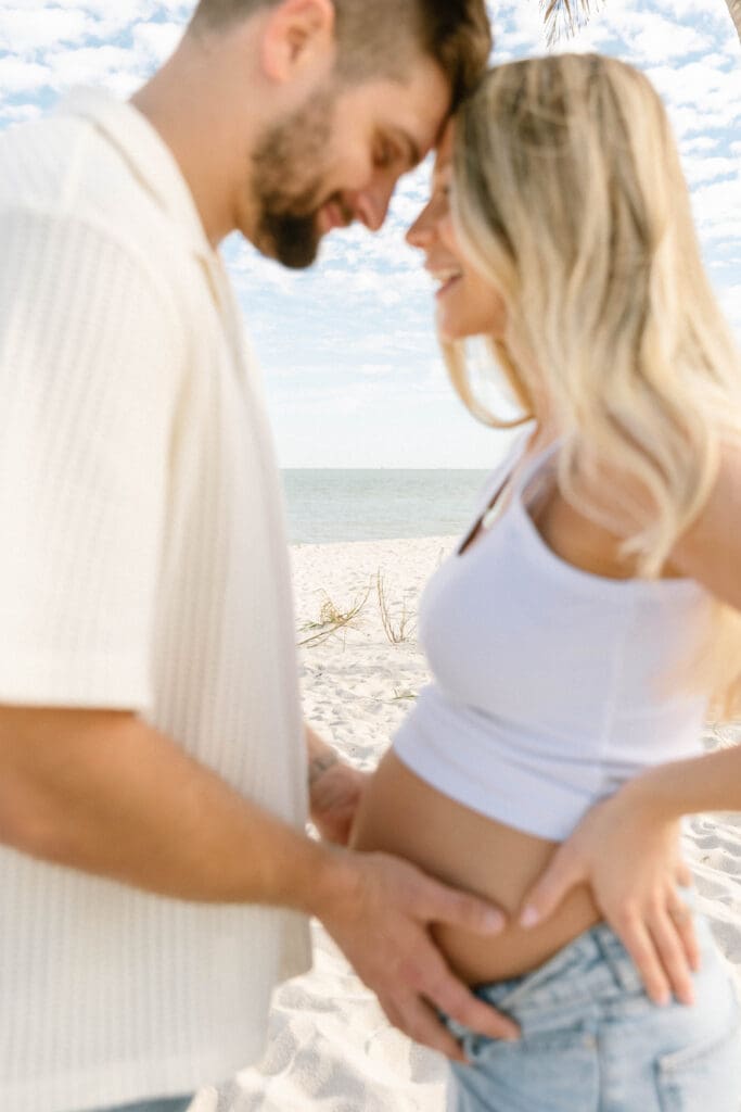 maternity session sanibel island couple laughing candid moment
