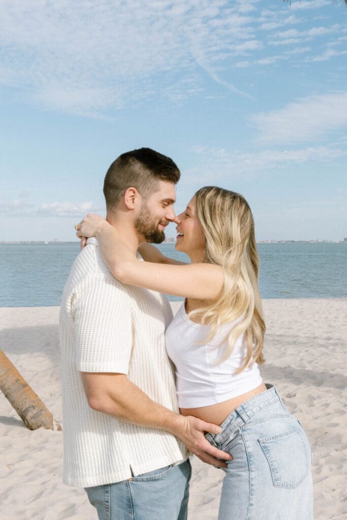 coastal maternity photos white outfit denim beach florida