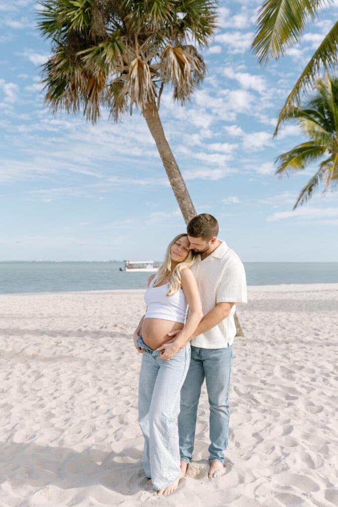 sanibel maternity photographer couple under palm trees
